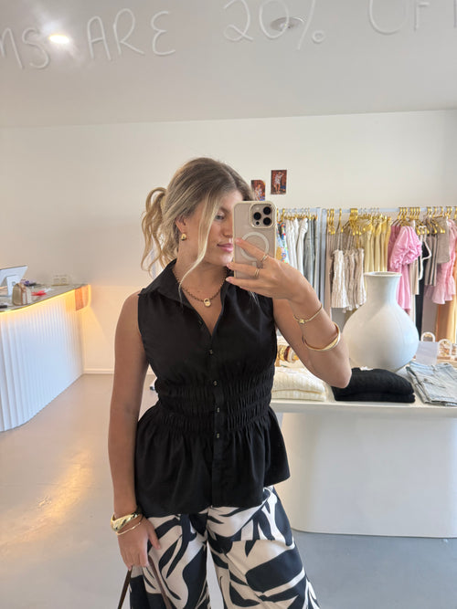 Black cinched waist sleeveless shirt